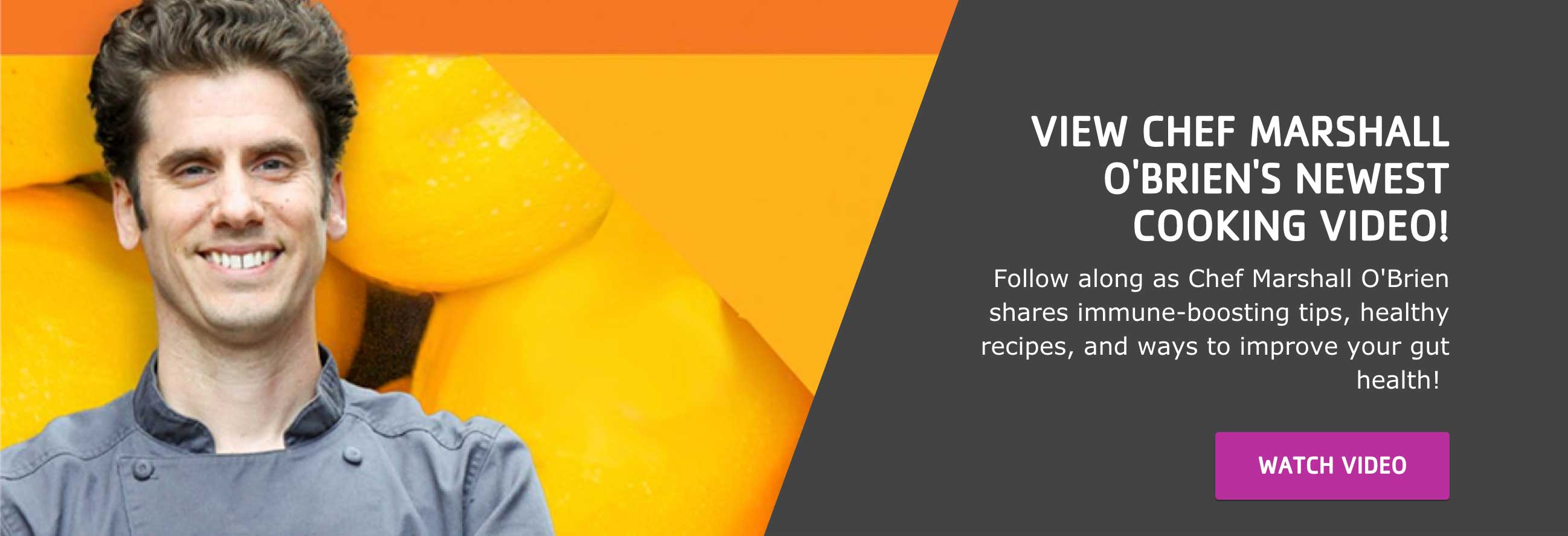 Chef Marshall O'Brien, Minneapolis local resident chef, stands in front of a yellow and orange background smiling