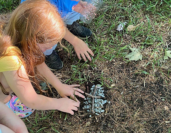 Icaghowan nature campers preparing a service for deceased toad found outside their cabin