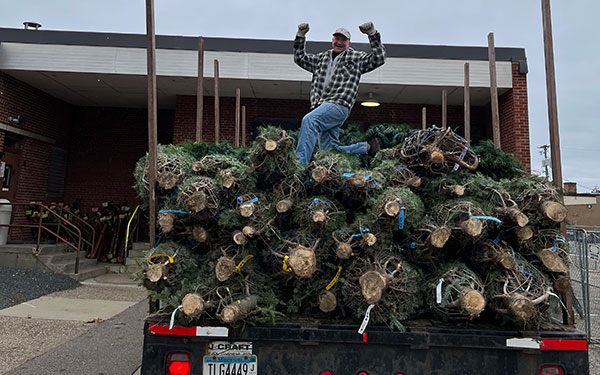 Steve having fun volunteering for the YMCA Christmas tree lots, supporting financial assistance program options for families in need