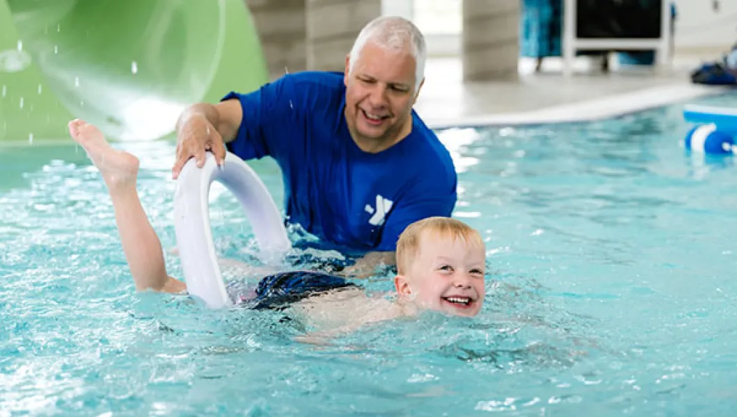 Swim instructor and student in the pool