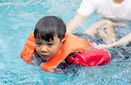 Man teaching boy to swim