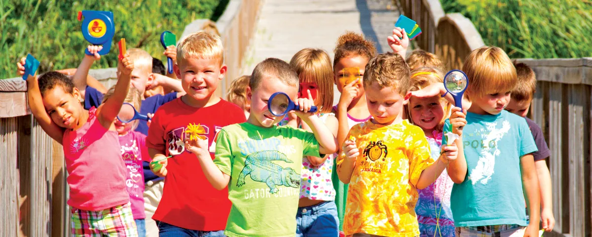 Preschool class with magnifying glasses