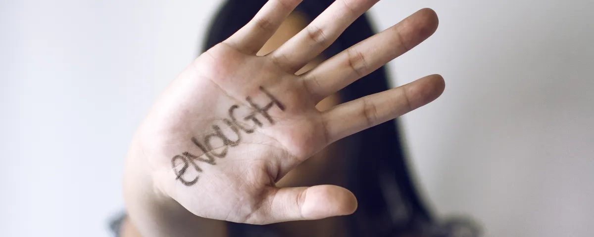 Young woman holding hand up to indicate 'stop'