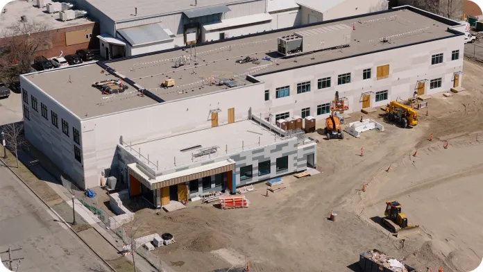 A close up view of the Peter J. King Center building construction site with machinery.