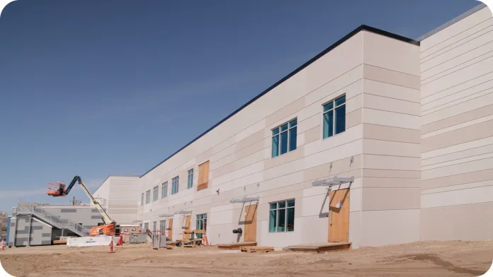 A close up view from the right of the Peter J. King Center building construction site with machinery.
