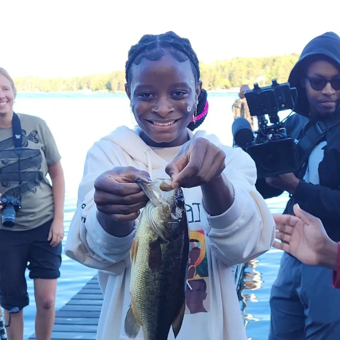 Miriam with her first-ever caught fish at Camp Northern Lights.