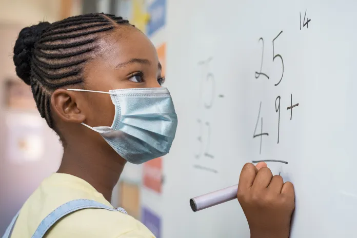 Student doing math at a whiteboard