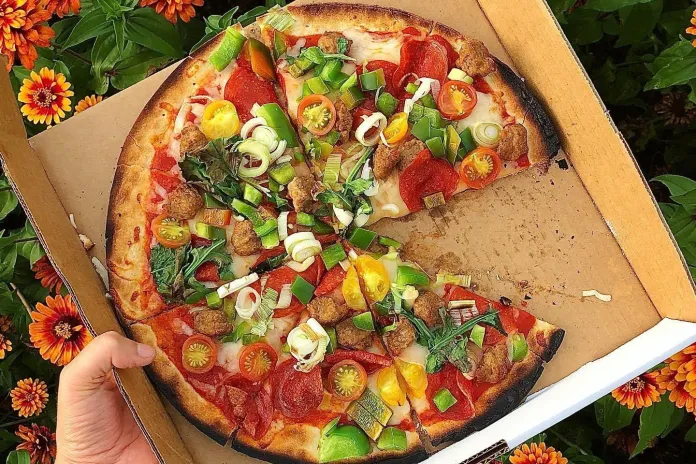 Pizza with flowers in the background