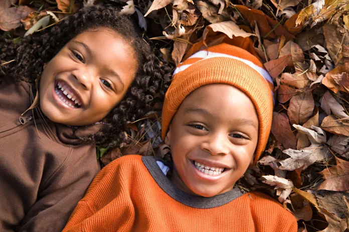 Kids laying on the ground in Autumn