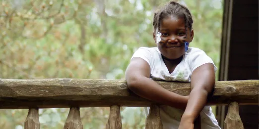 Smiling girl near cabin