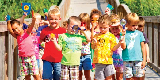 Preschool class with magnifying glasses