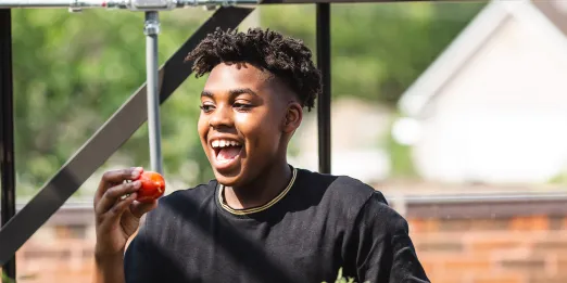 Teen eating fruit from the garden