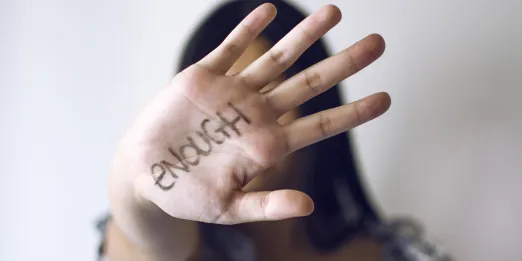 Young woman holding hand up to indicate 'stop'