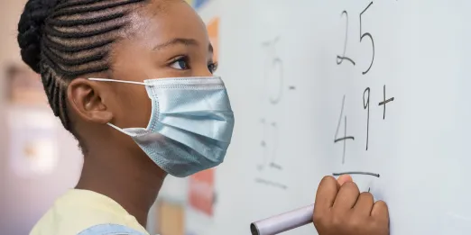 Student doing math at a whiteboard